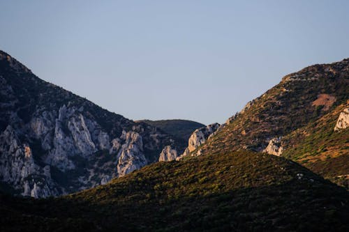 Rocky mountainous valley against cloudless sky