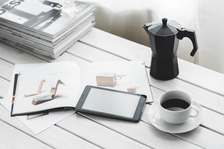 Digital Tablet With Cup Of Coffee On A White Desk