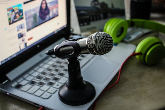 Green Headphones Near Laptop and Microphone