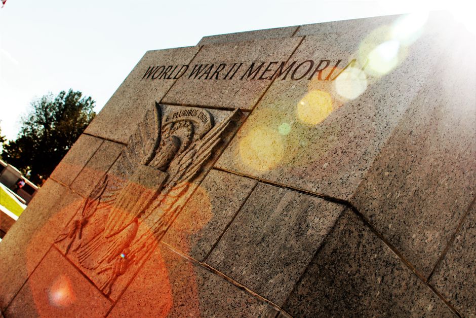 history of engraving - A striking view of a World War II memorial with lens flare enhancing its historic significance.