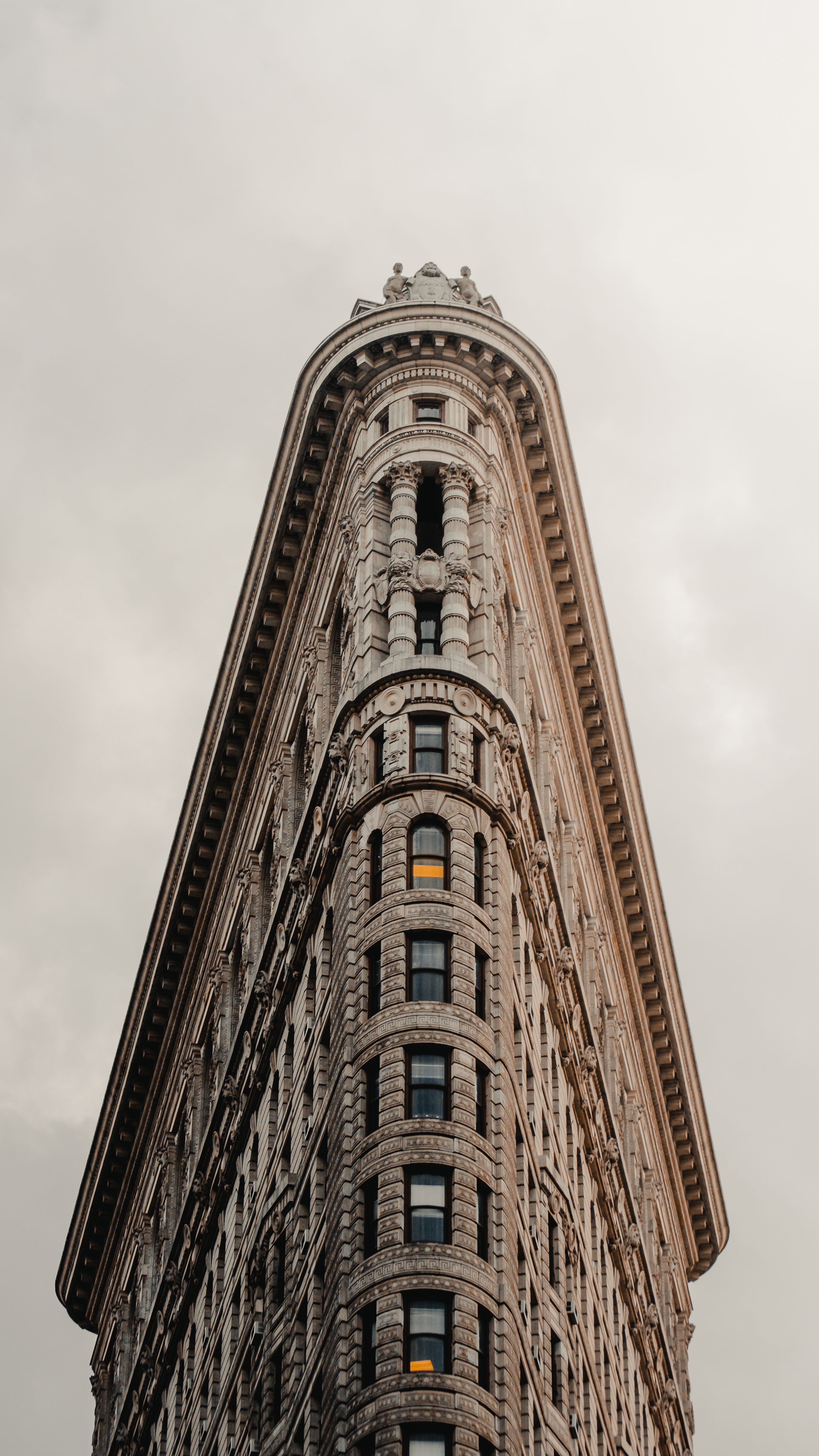 A Building with Ornate Details Under Cloudy Sky · Free Stock Photo