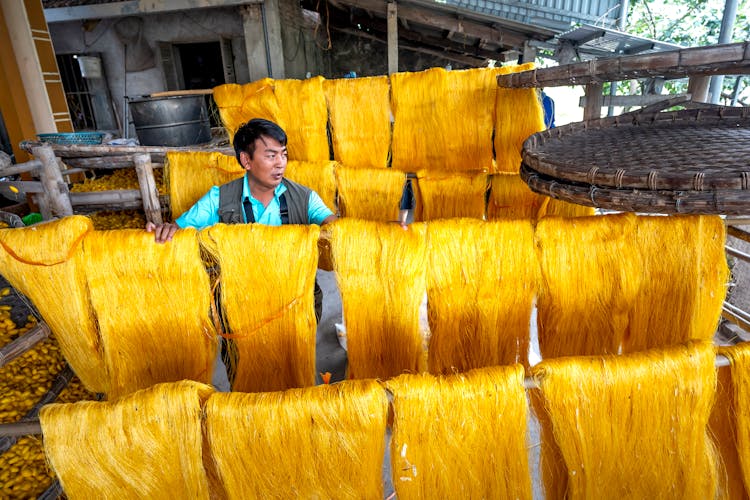 A Man Working On A Silk Production