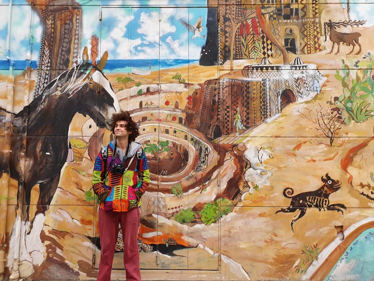 Portrait Of Man Standing In Front Of Mural