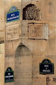 Close-up of historic street signs in Paris, capturing urban heritage and architecture.