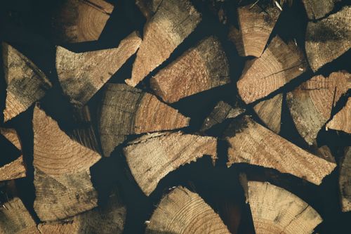 Free Close-up view of neatly stacked chopped firewood logs displaying natural textures. Stock Photo
