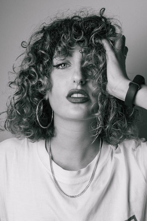 Grayscale Photo of a Woman with Curly Hair