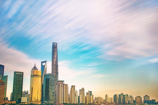 Shanghai skyline featuring iconic skyscrapers against a colorful dawn sky. Ideal for urban and architecture themes.