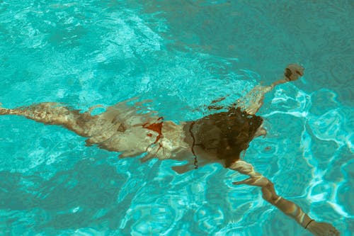 Free Woman in Red Bikini Swimming Stock Photo