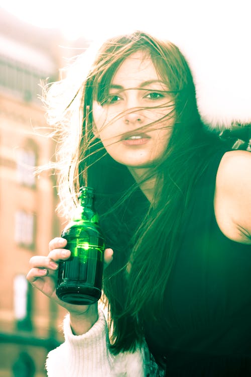 Free Woman In Black Sleeveless Shirt Holding A Bottle Stock Photo