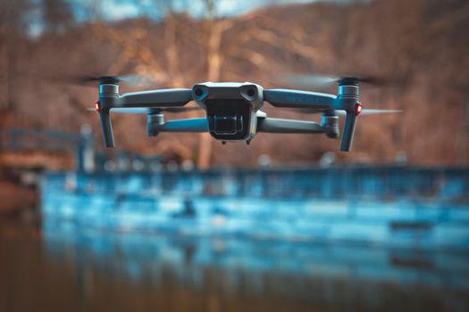 Close-up of a drone hovering over a calm body of water in Istanbul. Captured in scenic natural setting.