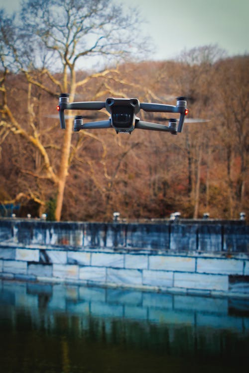 Free A Drone Camera Hovering Over the Lake Stock Photo
