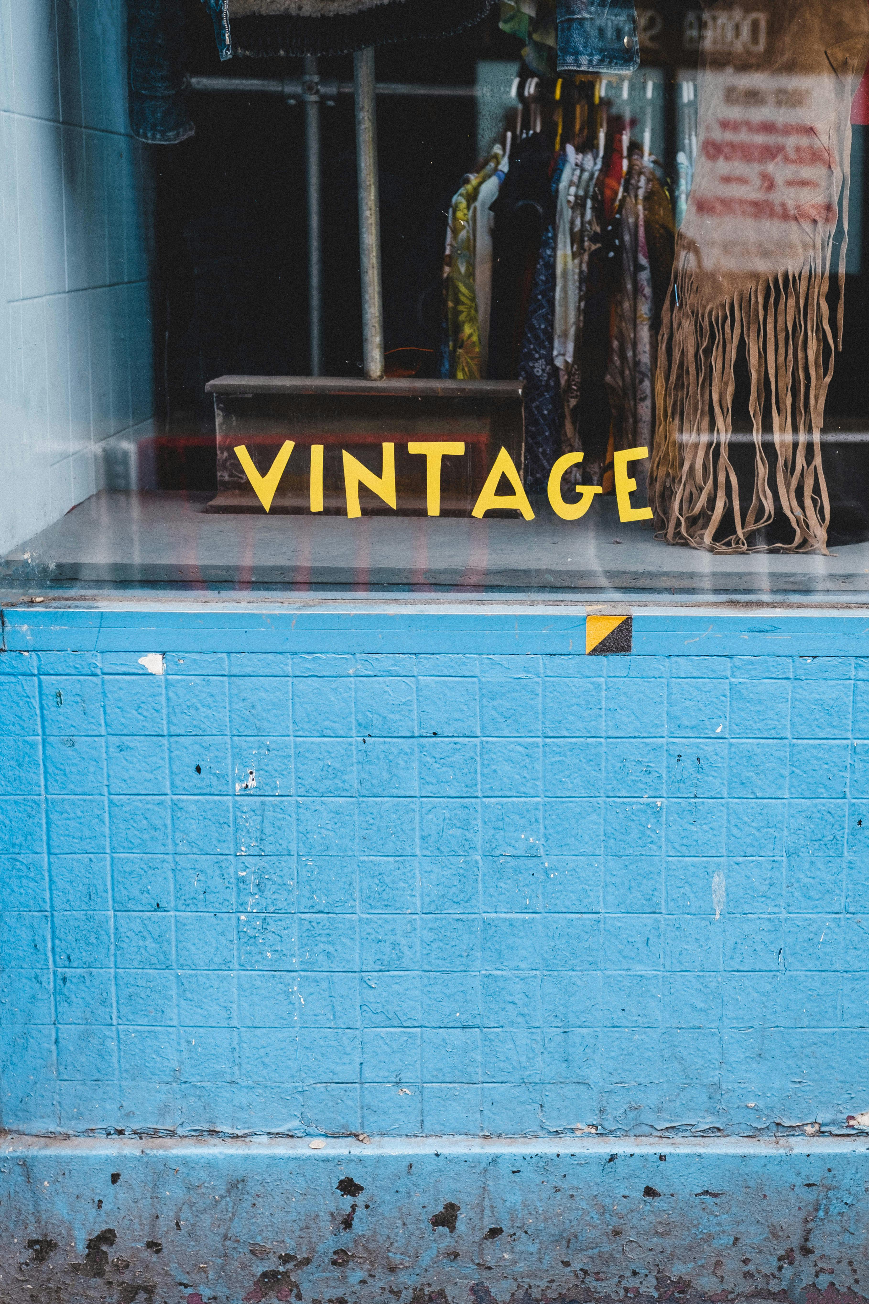 vintage inscription on showcase of shop with clothes