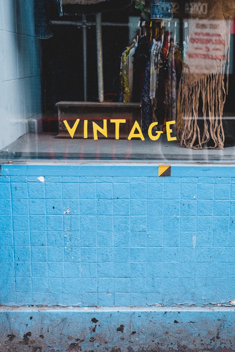 Vintage Inscription On Showcase Of Shop With Clothes