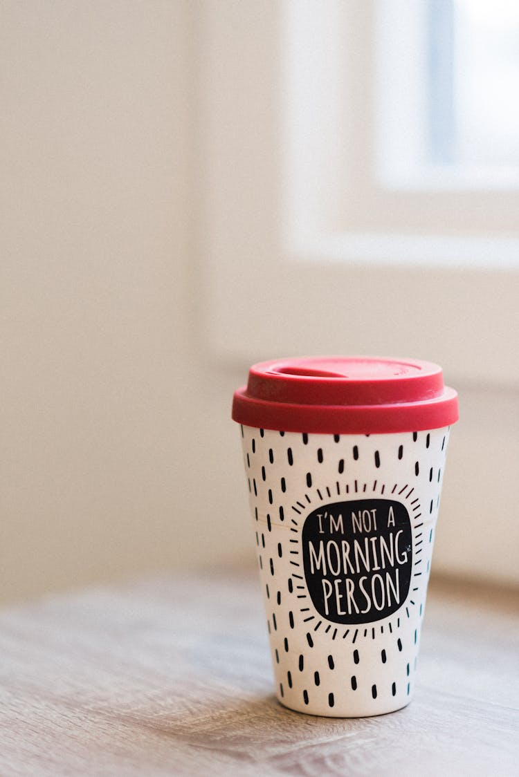 Coffee To Go With Ornament And Inscription On Table Indoors