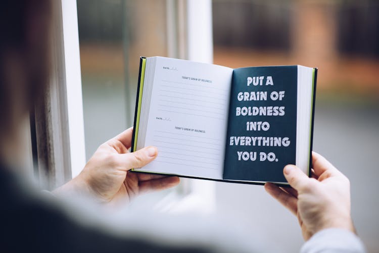 Faceless Man Demonstrating Message In Open Notebook At Home