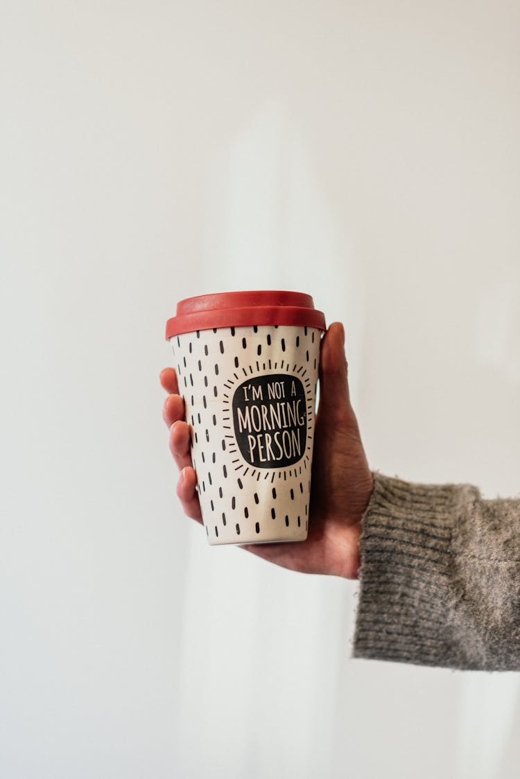 Crop Person With Takeaway Coffee On White Background