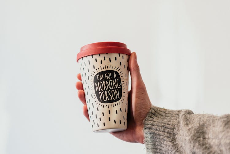 Faceless Person Showing Inscription On Coffee To Go