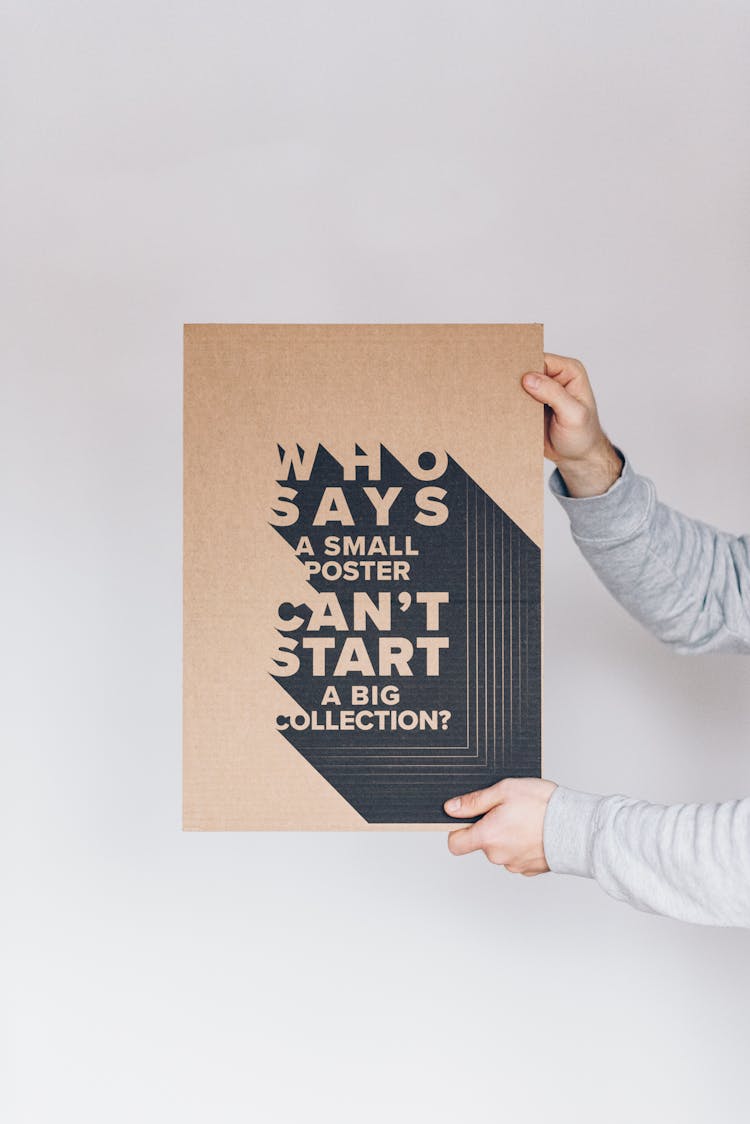 Crop Man Showing Poster With Inscription On White Background