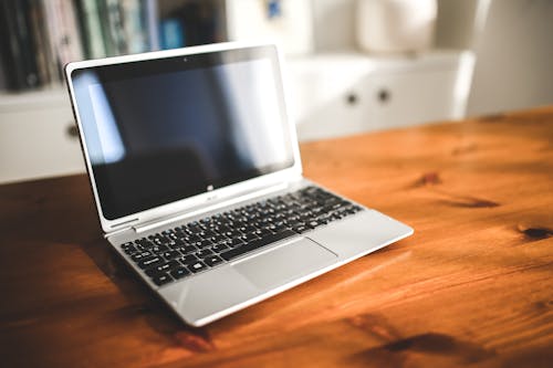 Opened laptop computer on a wooden desk