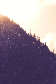 A dramatic silhouette of a mountain in Vysoké Tatry at sunset, dust particles visible.