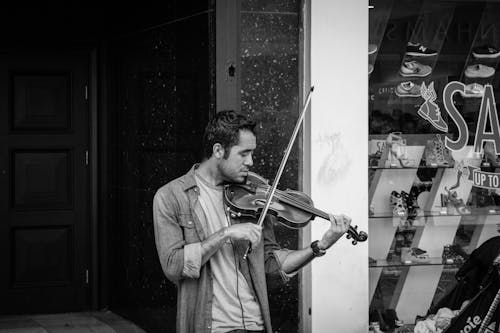 Grayscale Photo of Man Playing Violin