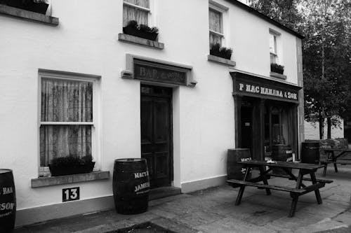 Free A Bar and Hotel Beside a Shop in Black and White  Stock Photo