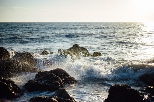 Photo of Blue Ocean Wave Coming to the Rocky Shore
