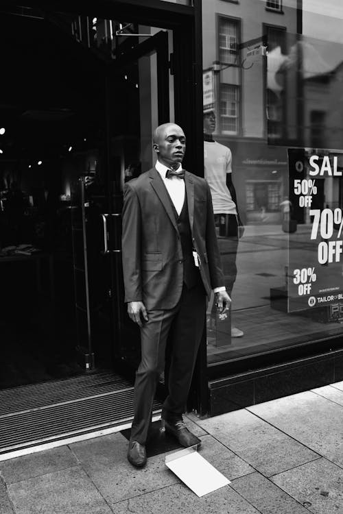 A Mannequin in Suit Standing on the Doorway 