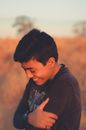 Laughing ethnic boy with closed eyes
