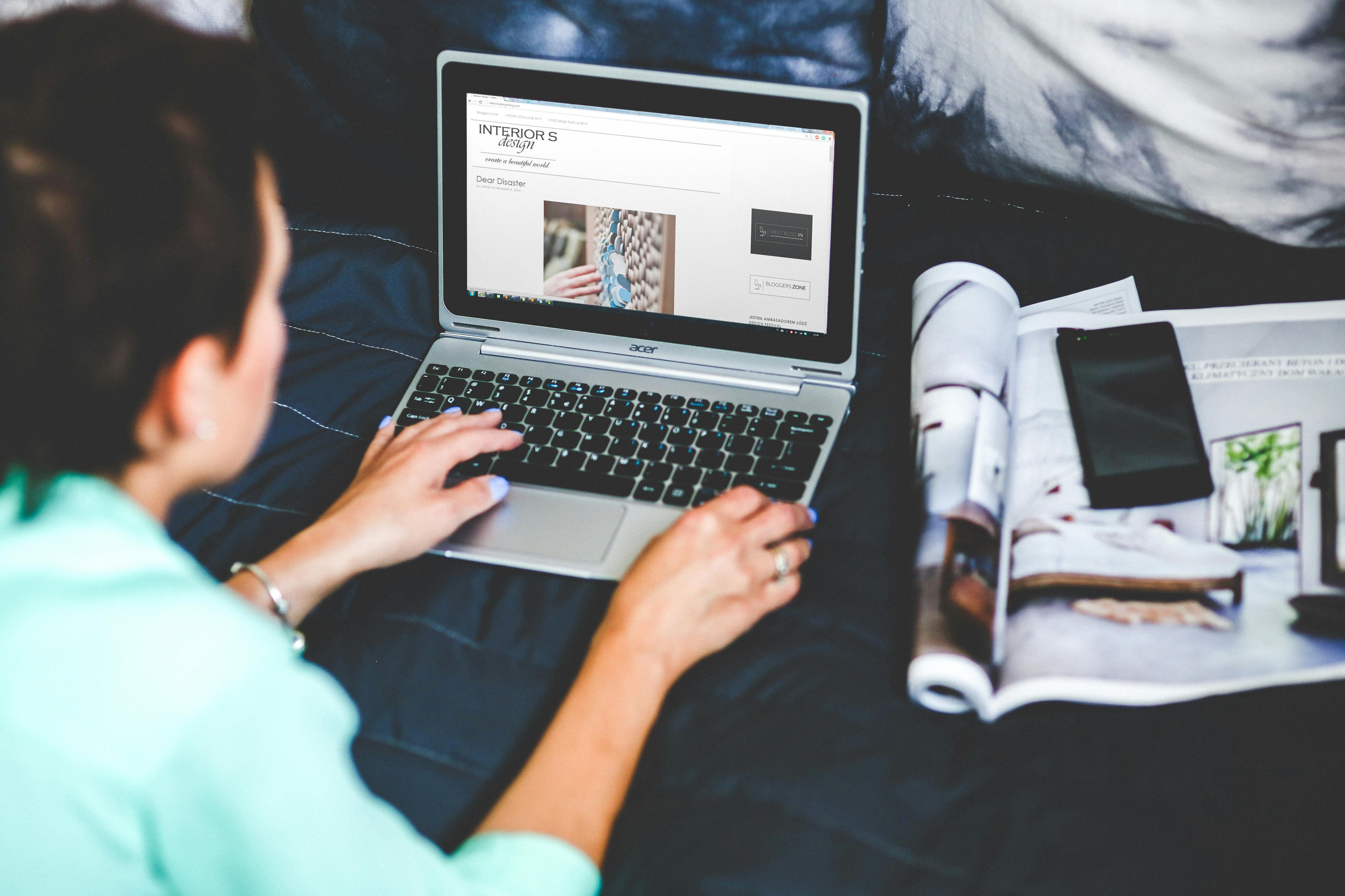 A woman browsing a catalog on her laptop