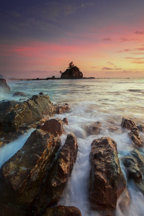 Running Water on Brown Rocks during Yellow Sunset