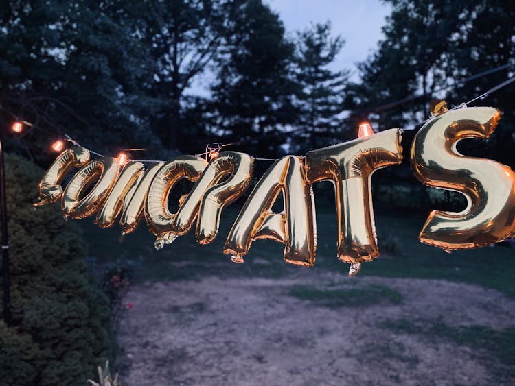 Close-Up Shot Of Gold Letter Balloons