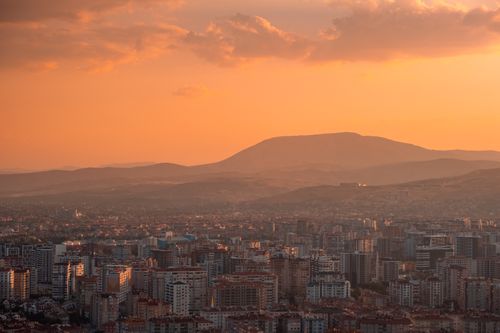 Free Captivating view of a city under vibrant orange skies during sunset, highlighting urban architecture. Stock Photo