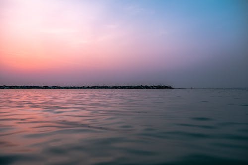 Calm Ocean Water during Sunset