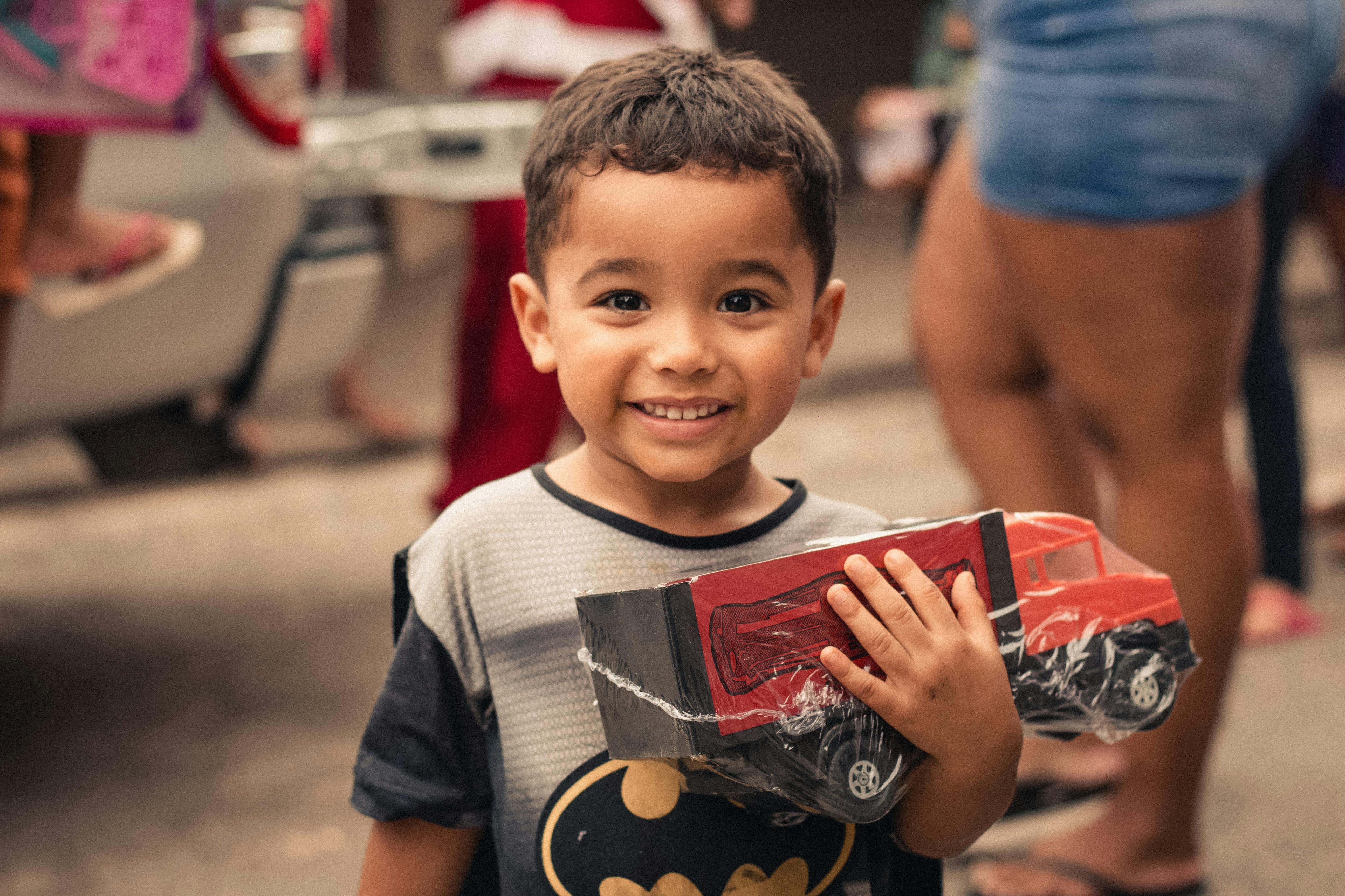 positive ethnic boy with toy