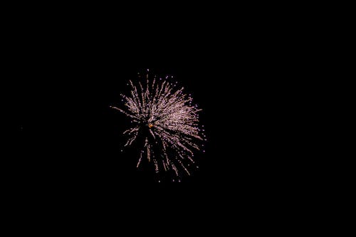 Glowing firework in dark sky