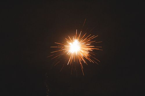 Free Colorful firework with golden sparks bursting on dark cloudless sky on black background during festive holiday celebration at night time Stock Photo