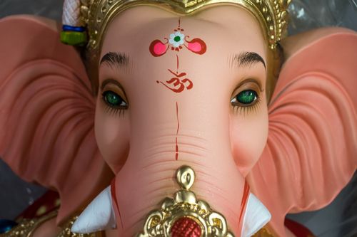 Free Captivating close-up of a Ganesh idol highlighting the vibrant colors and intricate designs of Indian craftsmanship. Stock Photo