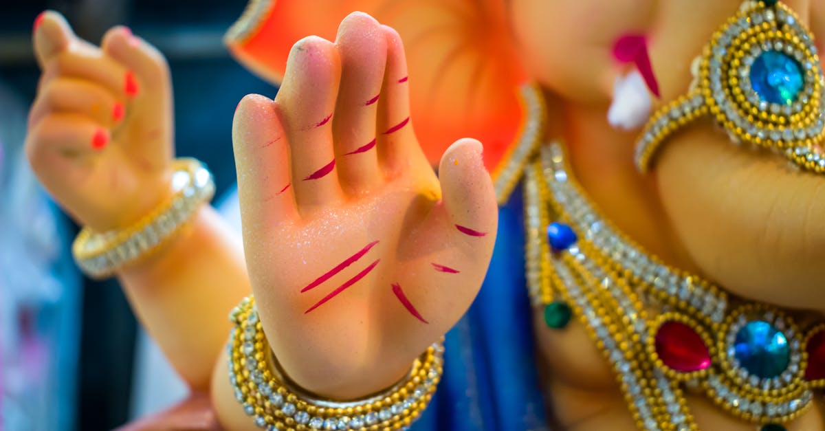 Vibrant close-up of Lord Ganesha idol, adorned in jewelry during Ganesh Chaturthi festival.