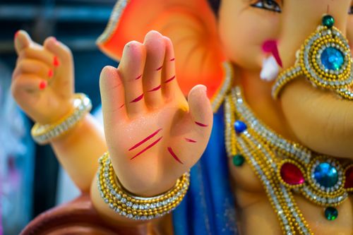 Free Vibrant close-up of Lord Ganesha idol, adorned in jewelry during Ganesh Chaturthi festival. Stock Photo