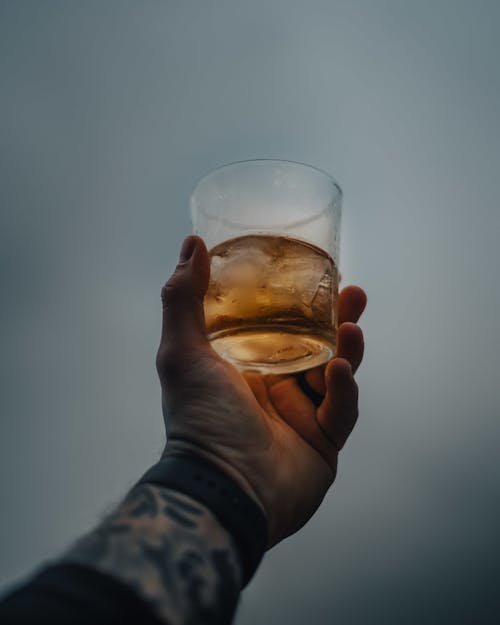 A Person's Hand Holding an Alcoholic Drink