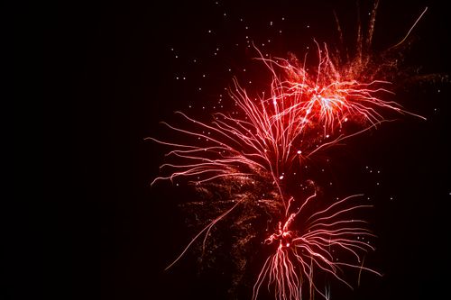Free Spectacular fireworks exploding against a dark night sky, creating a vibrant and colorful display. Stock Photo