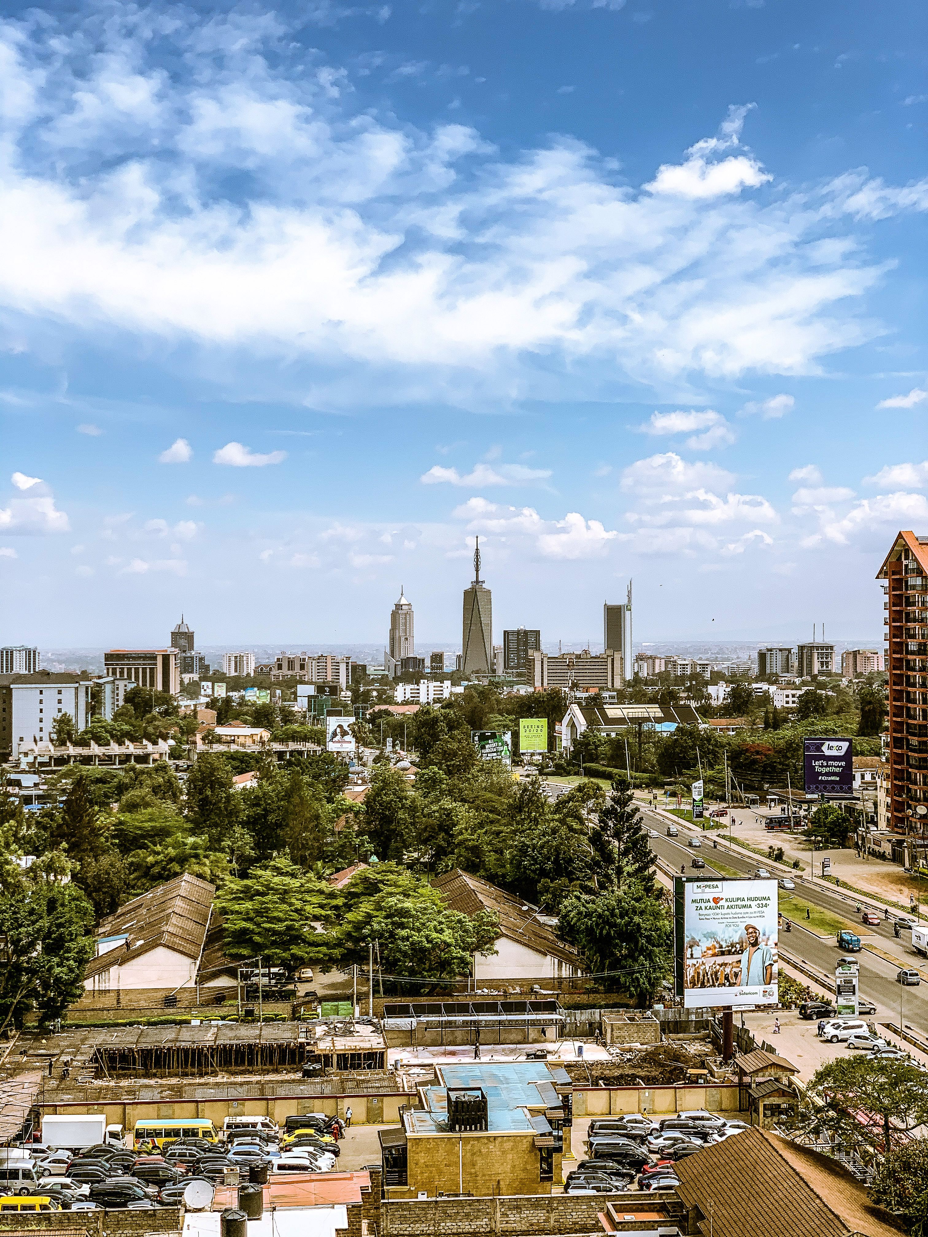 A vibrant view of Nairobi's skyline featuring tall skyscrapers and city bustling with activity.