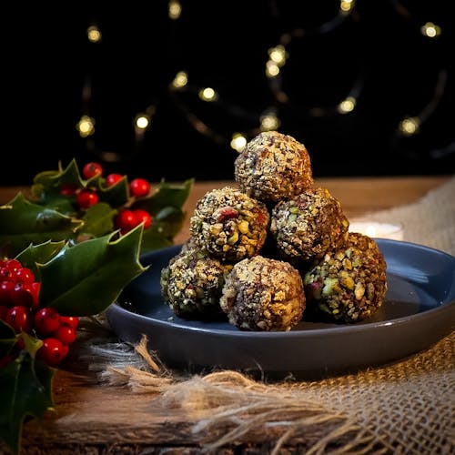 Free Delicious Truffles with Peanuts on a Blue Plate Beside Christmas Decors Stock Photo