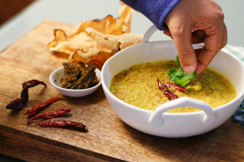 Bowl of spicy khichdi garnished with coriander