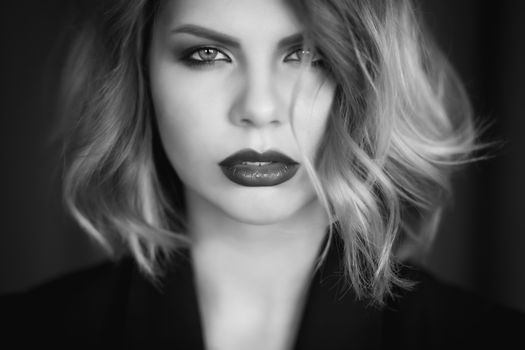Stunning black and white portrait of a woman with short hair and bold makeup.