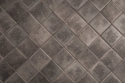 Free A Gray Tiled Surface with Diamond Shape Pattern Stock Photo