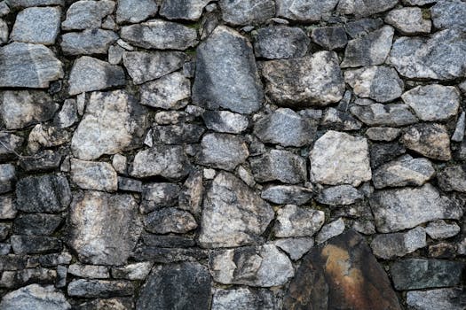 High-resolution image of a rugged stone wall for architectural and design projects.