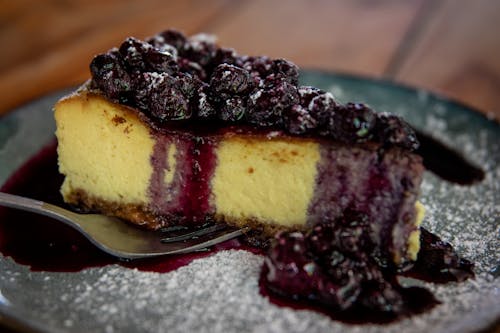 Free Blueberry Cheesecake on the Black Plate Stock Photo