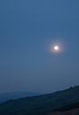 A Beautiful View of the Full Moon Over the Mountain
